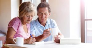 elderly couple reviewing their finances