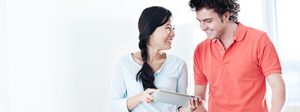 man and woman looking at financing agreement