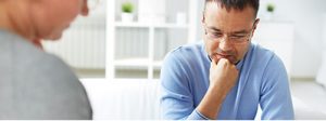 man with glasses considering life insurance
